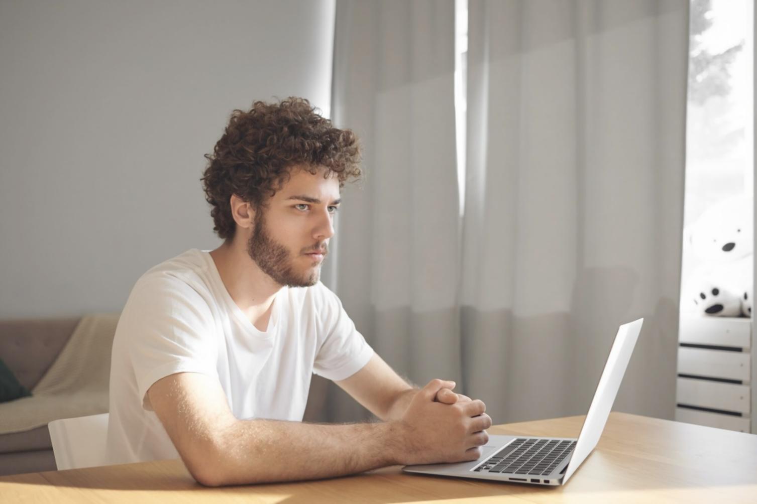 Person reviewing investment portfolio on laptop